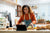 Woman cooking while following a online cooking course.